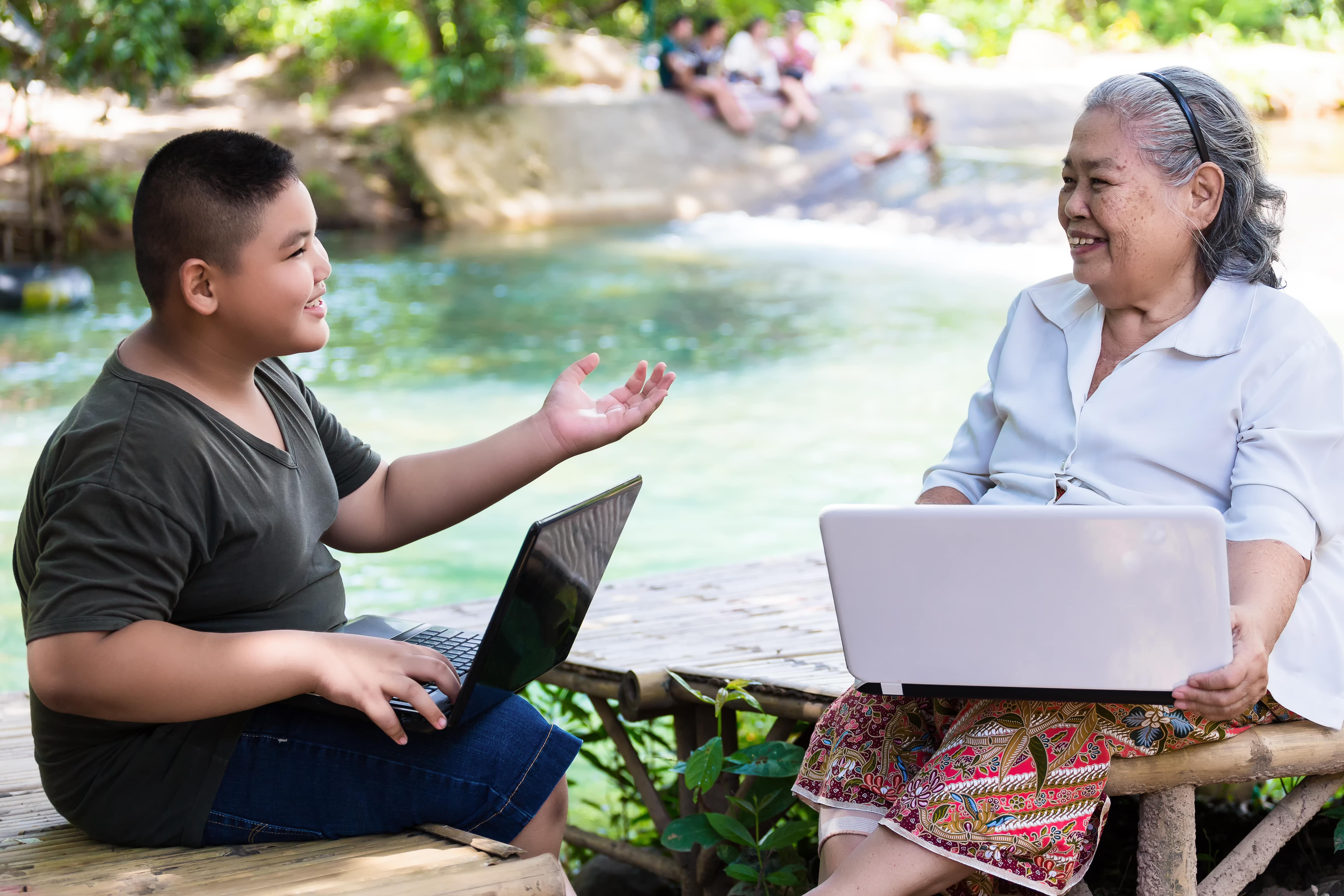 grandson-teaching-his-elderly-female-use-laptop-min.jpg