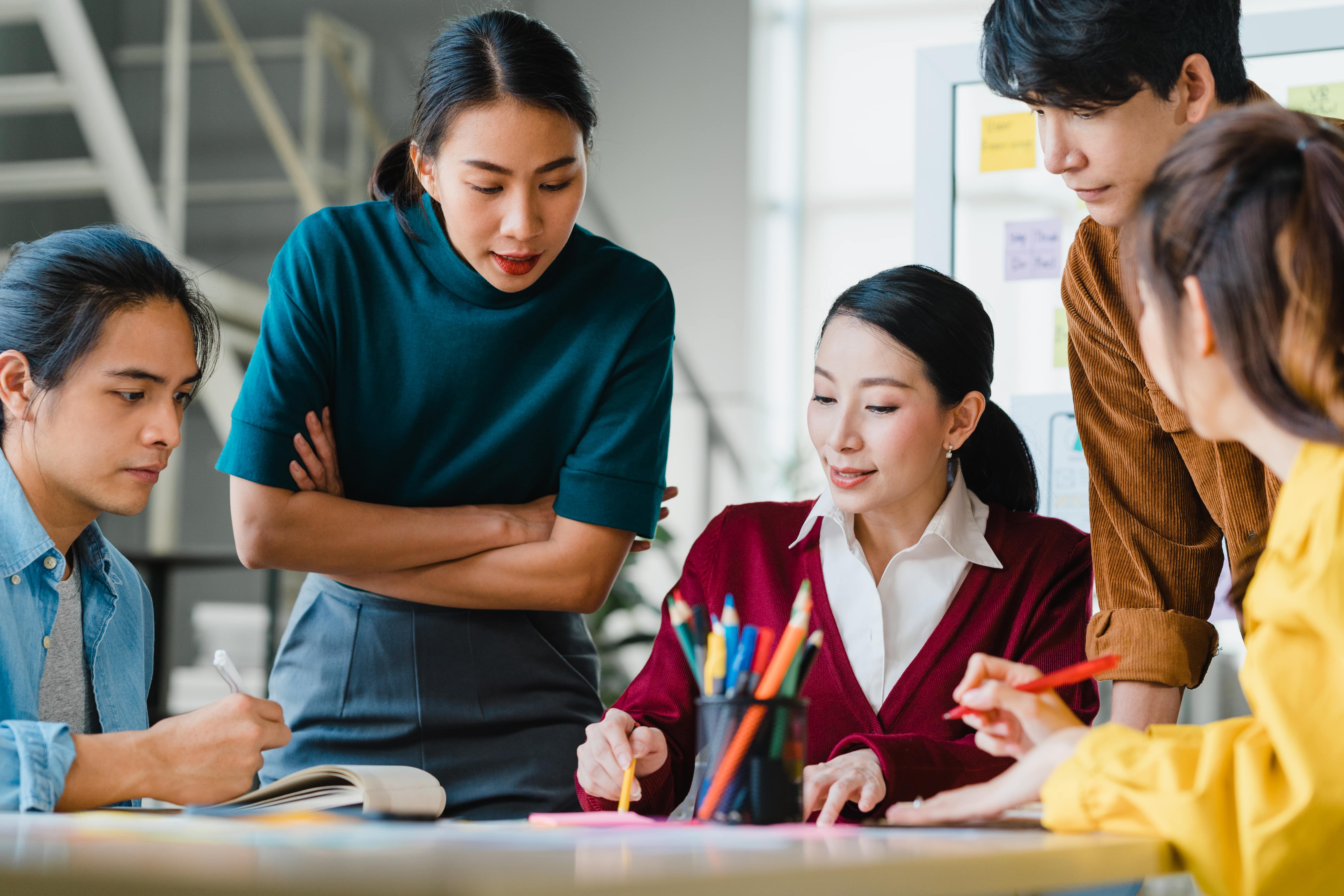 asian-businessmen-businesswomen-meeting-brainstorming-ideas-about-creative-web-design-planning-application-developing-template-layout-mobile-phone-project-working-together-small-office-min.jpg