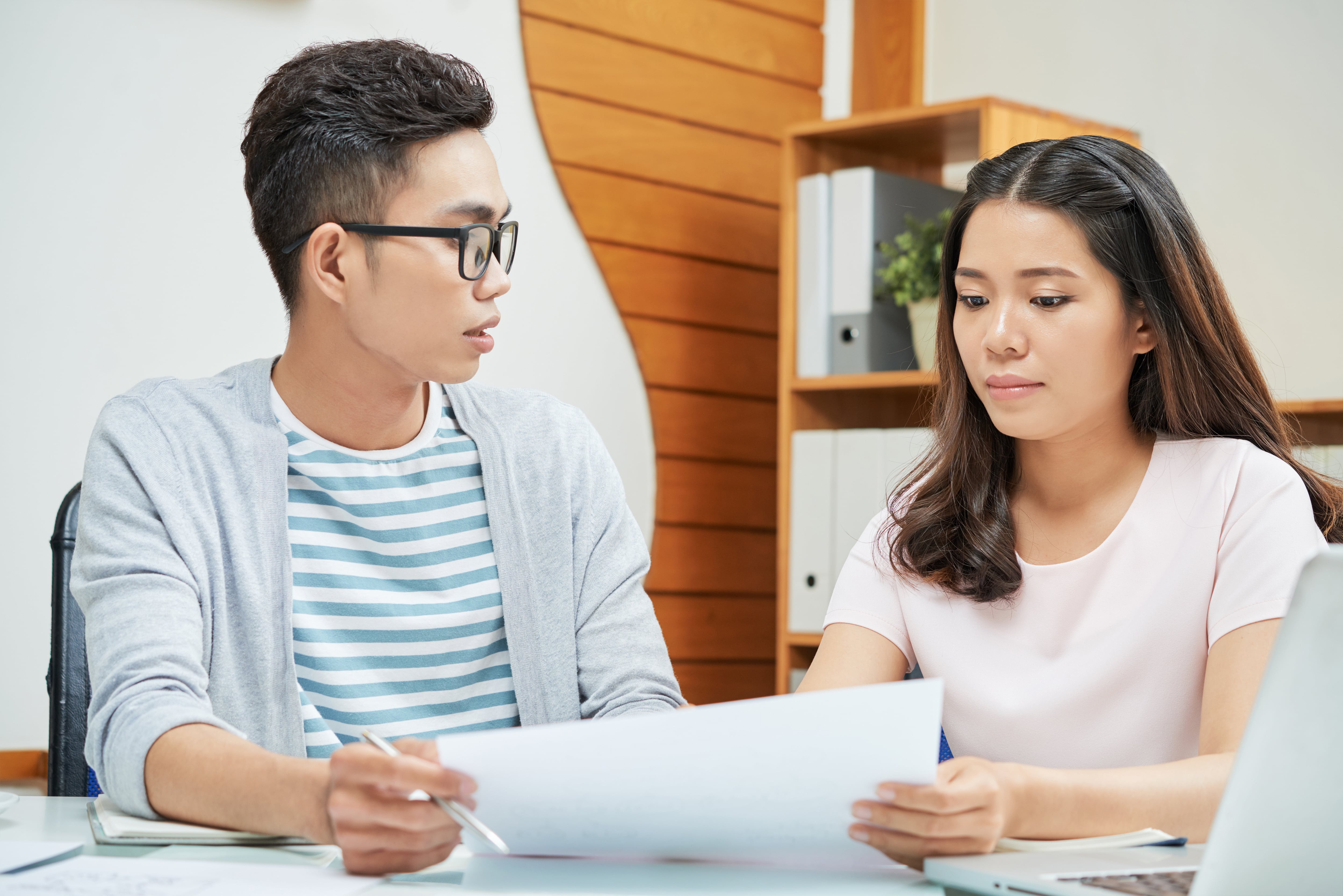 asian-young-colleagues-working-with-papers-min.jpg