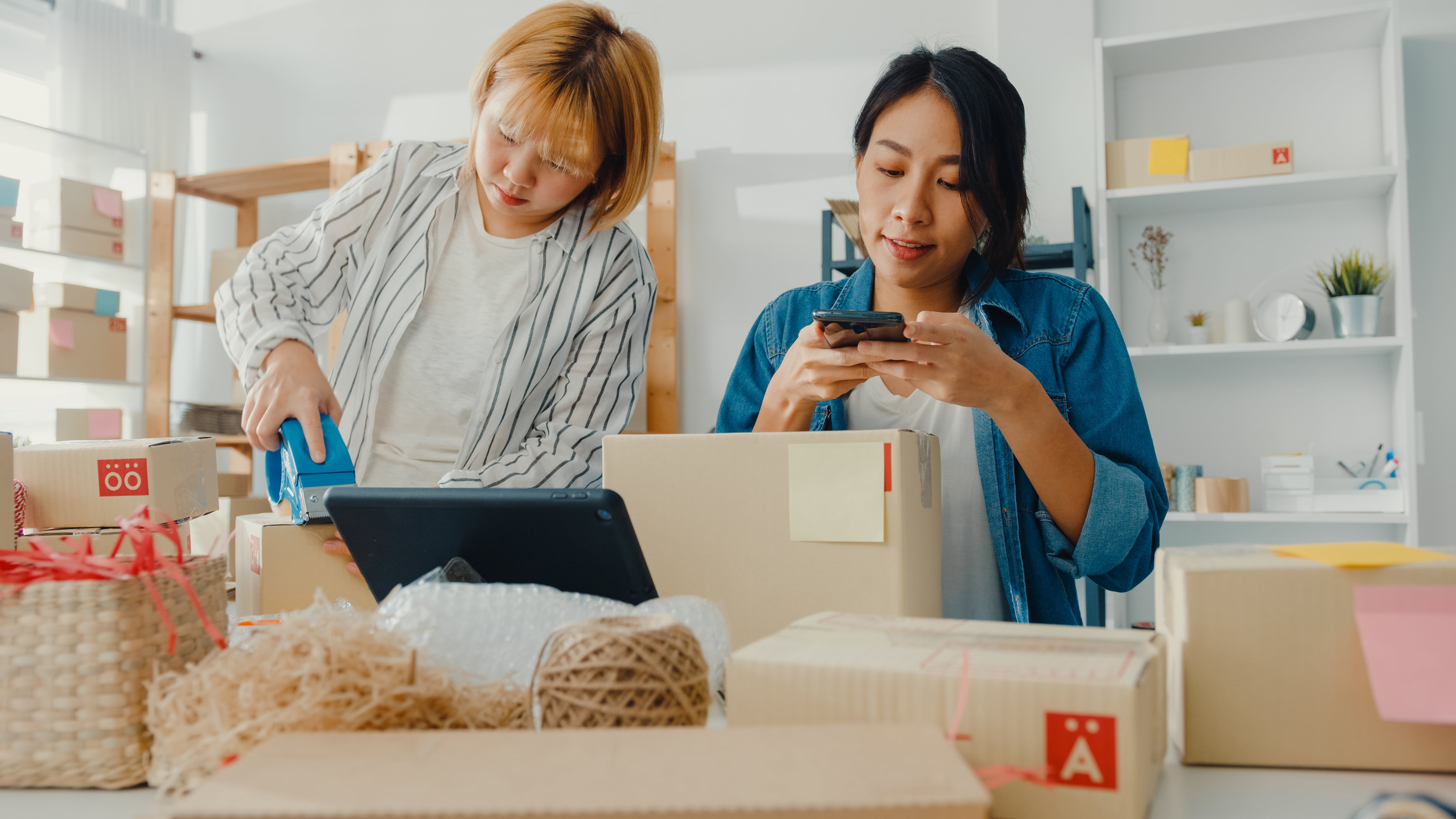 young-asian-businesswomen-using-mobile-phone-receiving-purchase-order-checking-product-stock-work-home-office-min.jpg